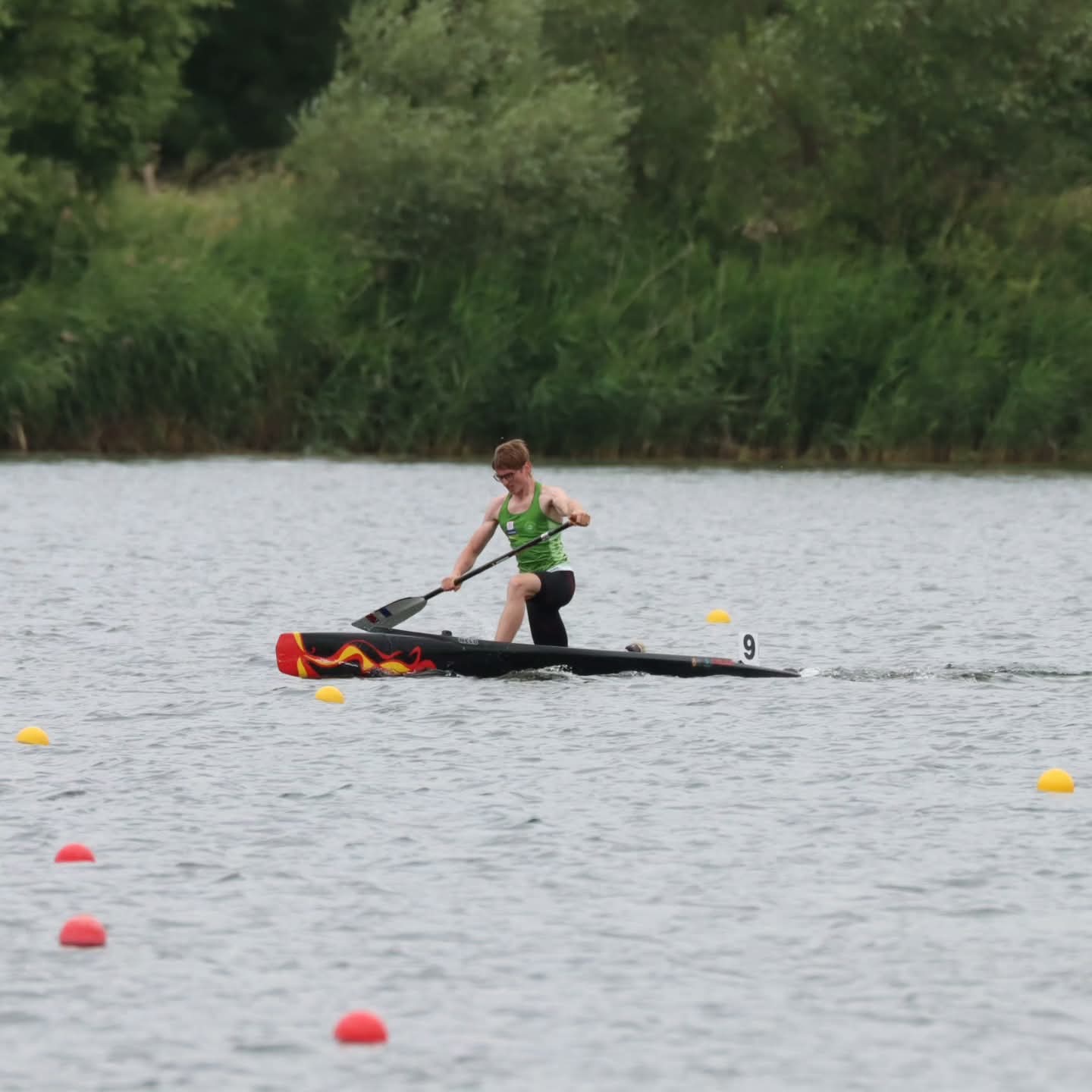 Floryan Courdent racing a C1 canoe between course buoys