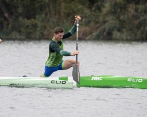 Floryan Courdent paddling a green C1 canoe
